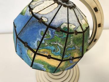 Earth globe with axis and rotating bracket in segment technology 